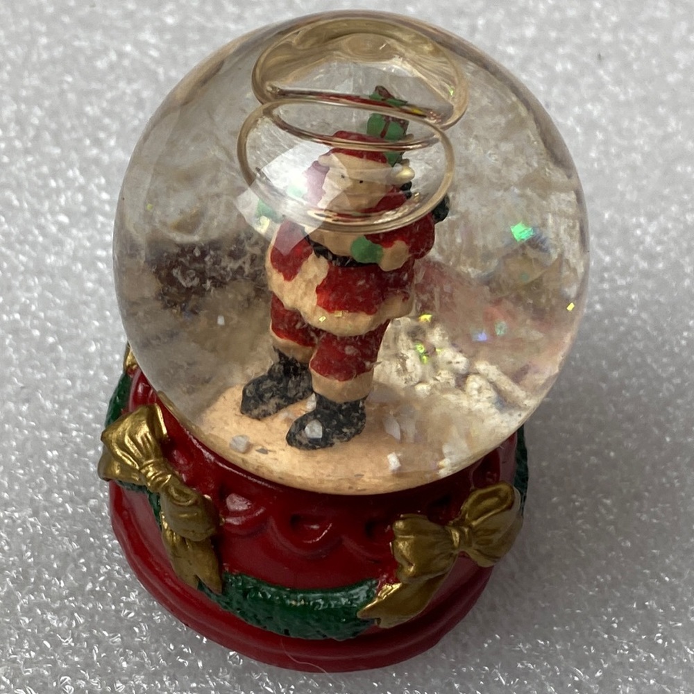 Vintage snow globe with Santa Claus and golden bow base
